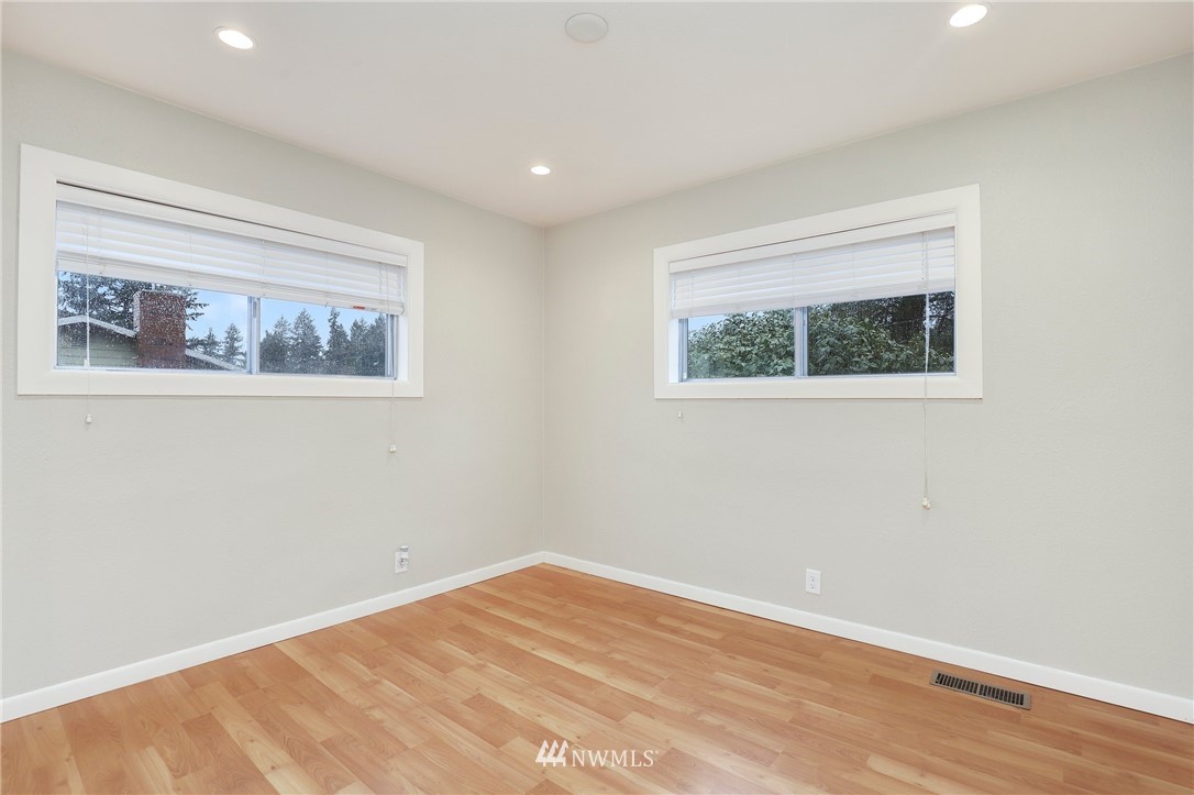 617 Reiten Road Kent, WA 98030 - Photo 13 of 30 a view of an empty room with wooden floor and a window