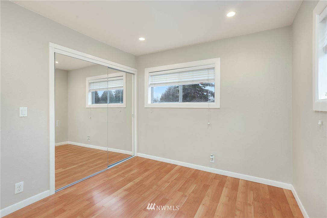 617 Reiten Road Kent, WA 98030 - Photo 14 of 30 a view of an empty room with wooden floor and a window