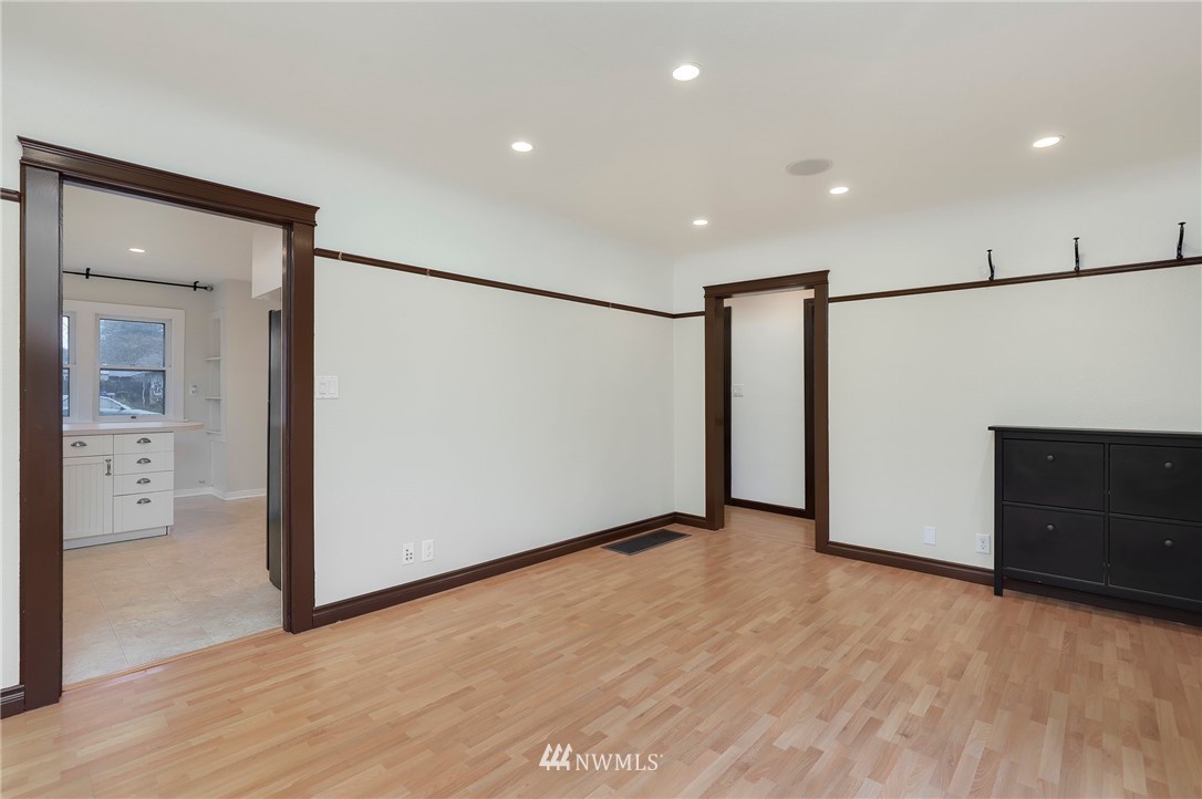 617 Reiten Road Kent, WA 98030 - Photo 5 of 30 a view of an empty room with wooden floor and a kitchen