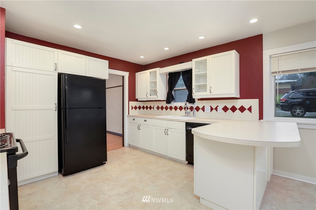 617 Reiten Road Kent, WA 98030 - Photo 7 of 30 a kitchen with a sink stainless steel appliances and cabinets