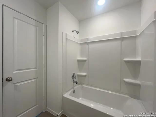 a bathroom with a bathtub and toilet
