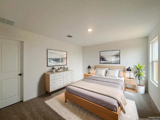 a bedroom with a bed and a painting on the wall