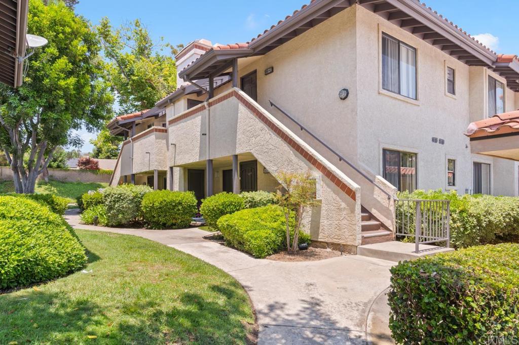 980 Lupine Hills Drive, Unit 81 Vista, CA 92081 - Photo 1 of 47 a front view of a house with a yard and potted plants