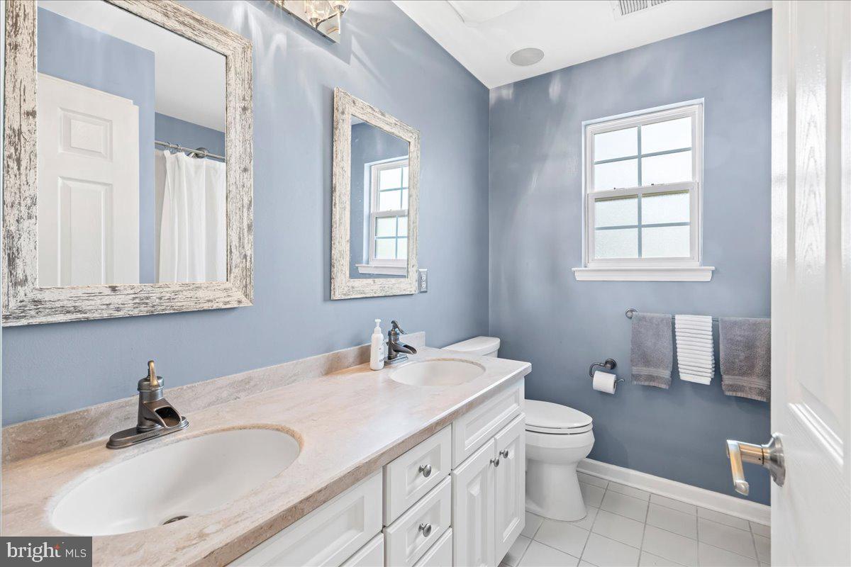 2650 Valhalla Road Vineland, NJ 08361 - Photo 23 of 49 a bathroom with double vanity sink a mirror and a toilet
