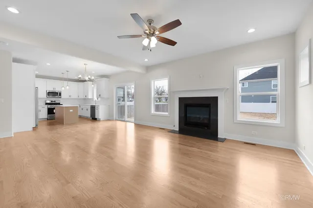 a view of an empty room with a fireplace and a window