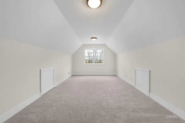 an empty room with windows and entrance