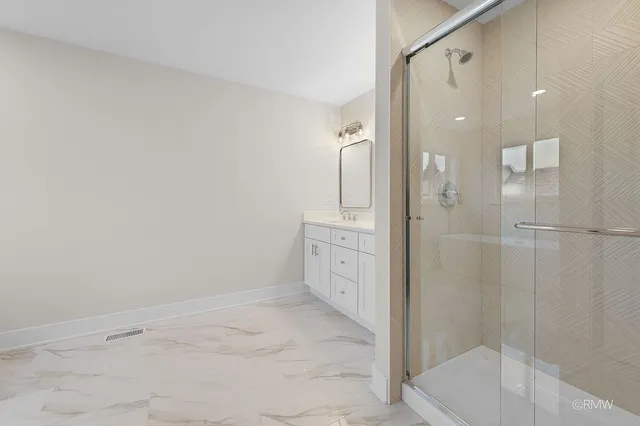 a bathroom with a glass shower door