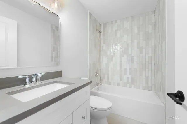 a bathroom with a sink a toilet and a bathtub