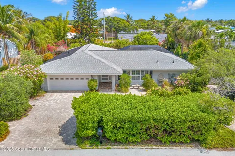 a view of a house with a yard and garden