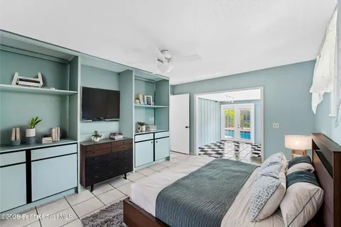 a bedroom with a bed and a flat screen tv