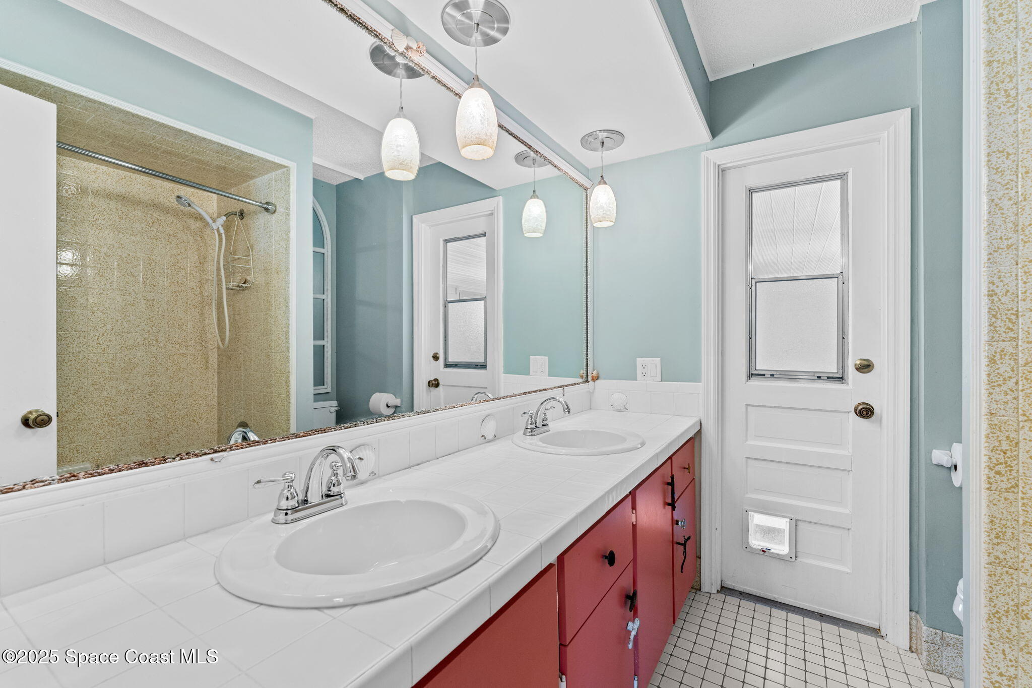 544 Solitaire Palm Drive Indialantic, FL 32903 - Photo 20 of 37 a bathroom with a double vanity sink and a mirror