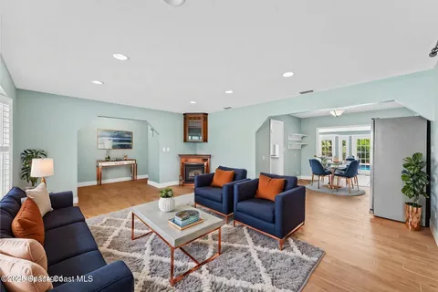 a living room with furniture and wooden floor