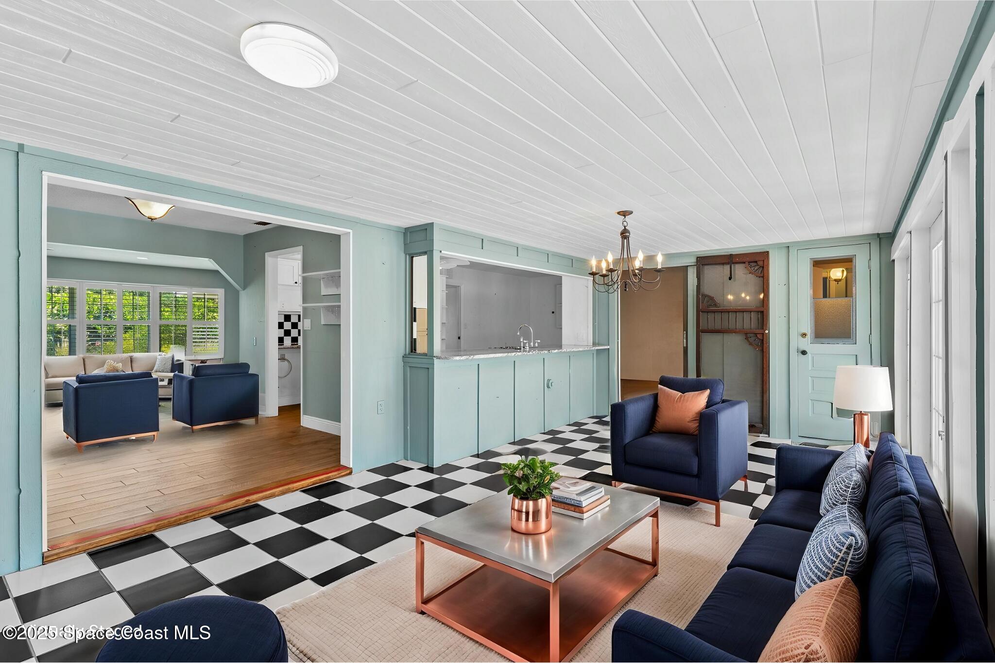 544 Solitaire Palm Drive Indialantic, FL 32903 - Photo 5 of 37 a living room with furniture a rug and a chandelier