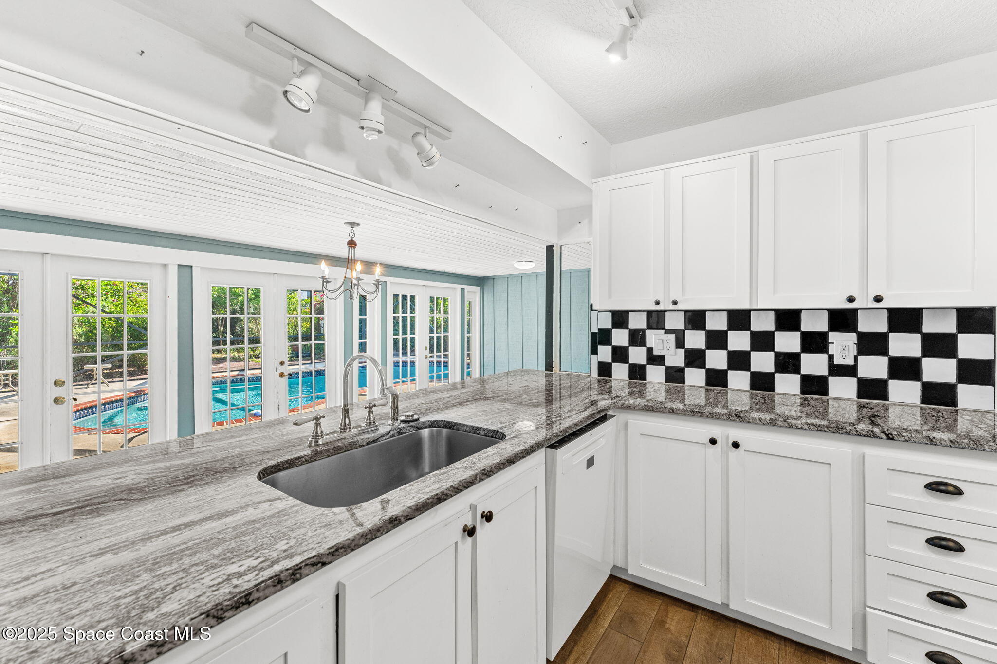 544 Solitaire Palm Drive Indialantic, FL 32903 - Photo 8 of 37 a kitchen with granite countertop a sink and cabinets