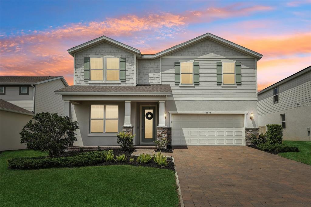 2575 Auburn Ridge Drive Apopka, FL 32712 - Photo 1 of 48 a front view of a house with a yard and garage