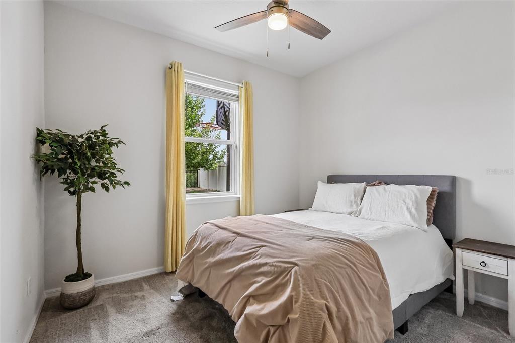 2575 Auburn Ridge Drive Apopka, FL 32712 - Photo 20 of 48 a bed sitting in a bedroom next to a window