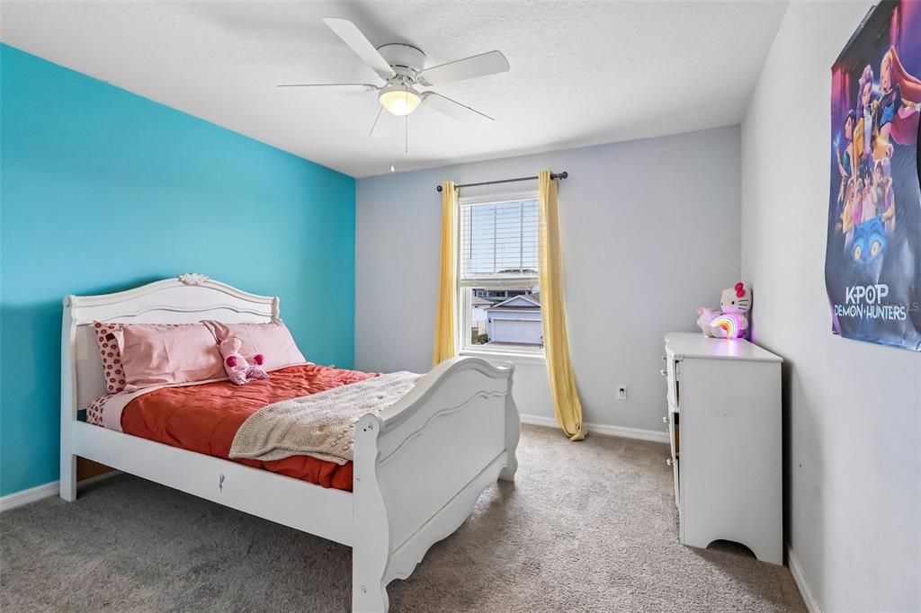 2575 Auburn Ridge Drive Apopka, FL 32712 - Photo 23 of 48 a bedroom with a bed and a chandelier