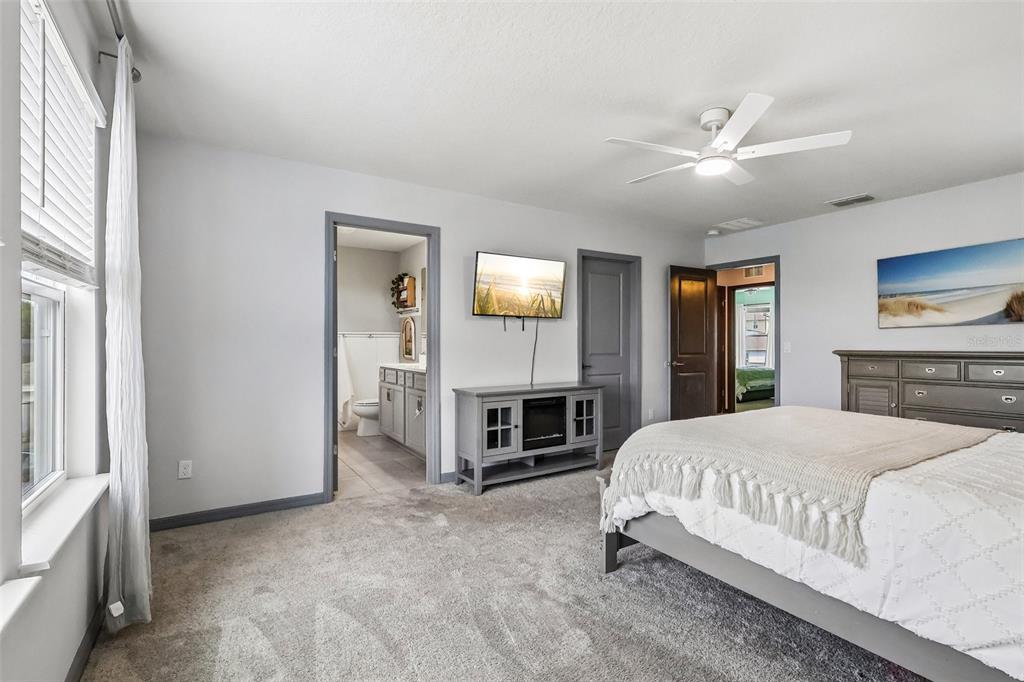 2575 Auburn Ridge Drive Apopka, FL 32712 - Photo 30 of 48 a bedroom with a bed and a fireplace