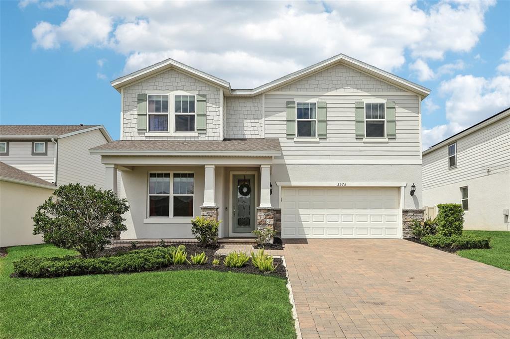 2575 Auburn Ridge Drive Apopka, FL 32712 - Photo 3 of 48 a front view of a house with a yard and garage