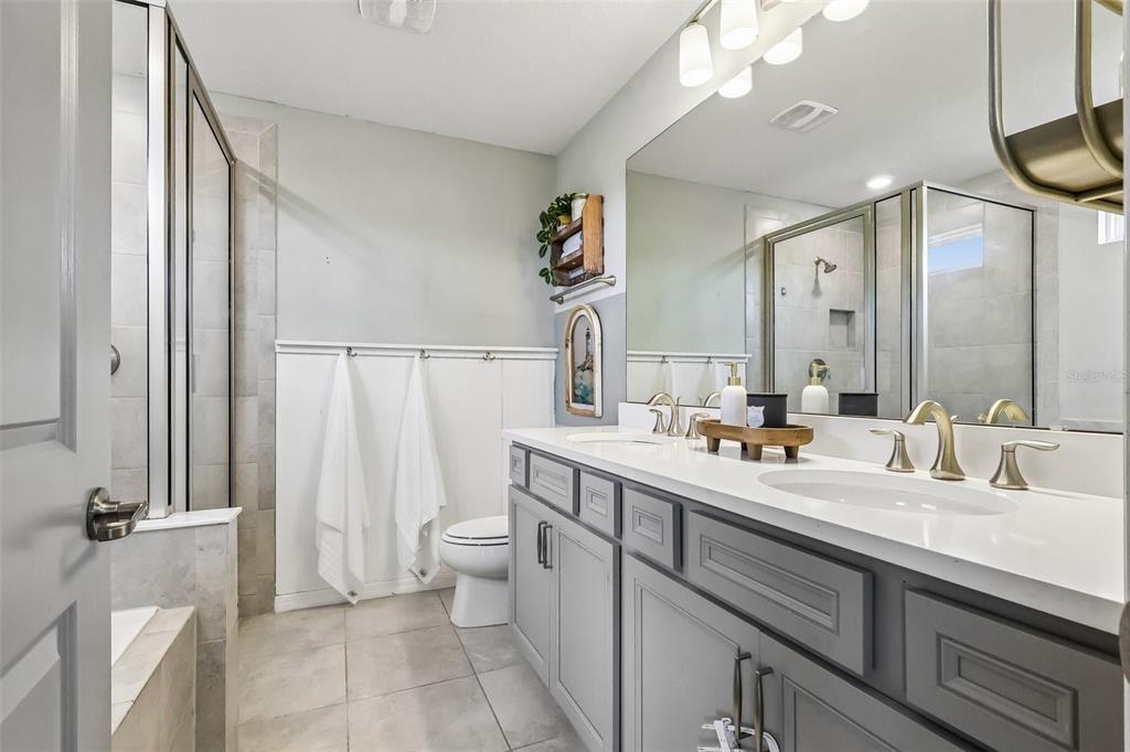 2575 Auburn Ridge Drive Apopka, FL 32712 - Photo 31 of 48 a bathroom with a double vanity sink a toilet and a mirror