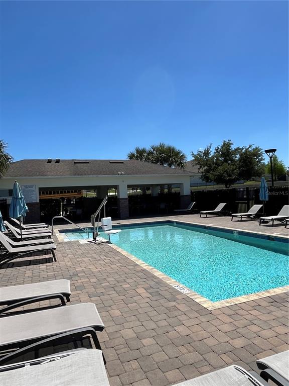 2575 Auburn Ridge Drive Apopka, FL 32712 - Photo 46 of 48 a view of a swimming pool with a yard