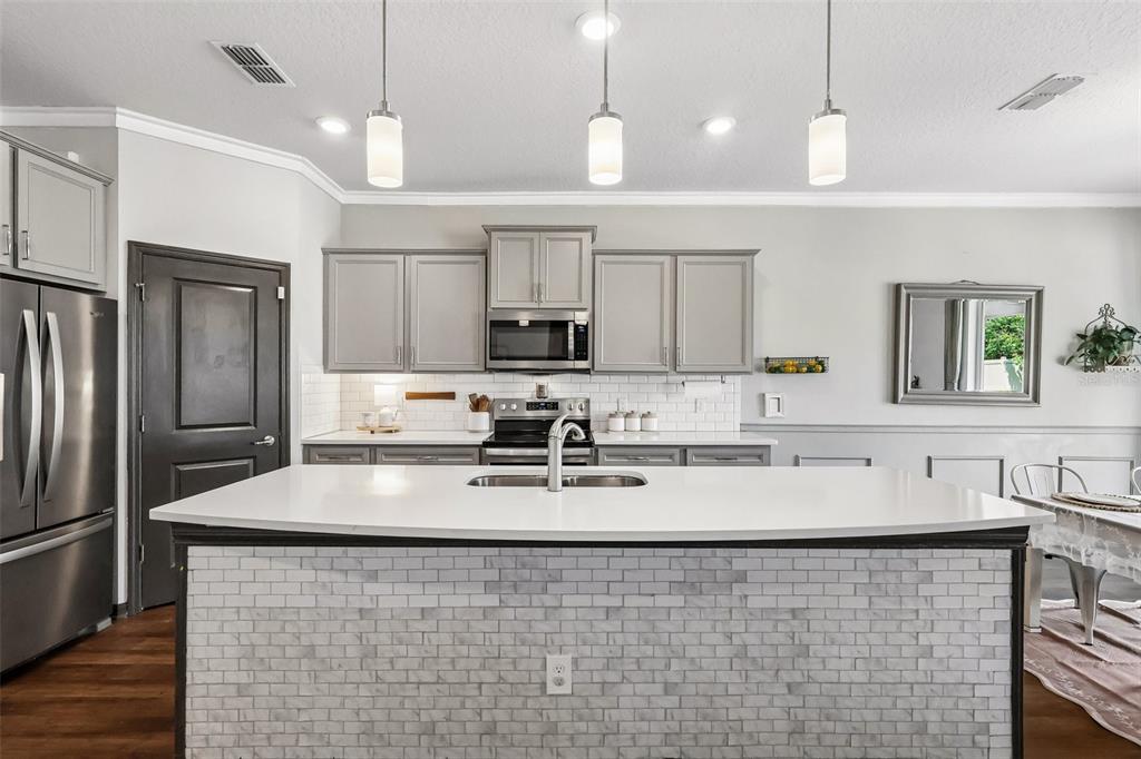 2575 Auburn Ridge Drive Apopka, FL 32712 - Photo 10 of 48 a kitchen with kitchen island a sink stainless steel appliances and cabinets