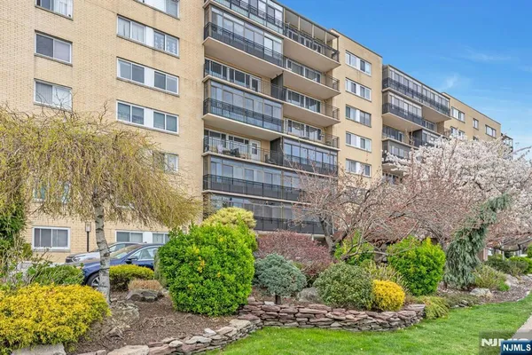 a view of a tall building and an garden