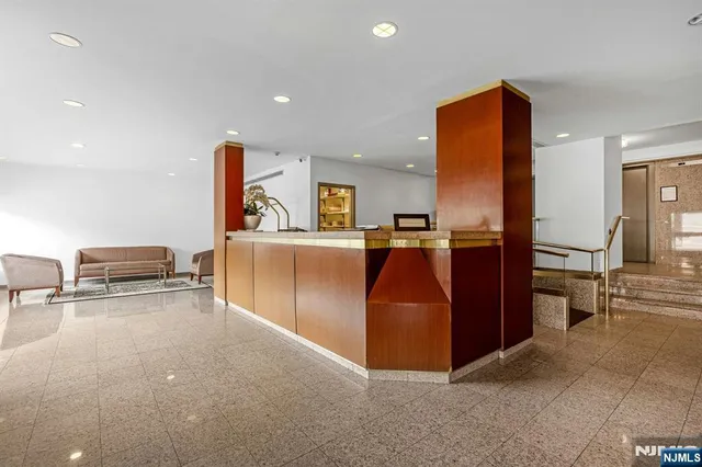 a kitchen with stainless steel appliances kitchen island granite countertop a refrigerator and stove