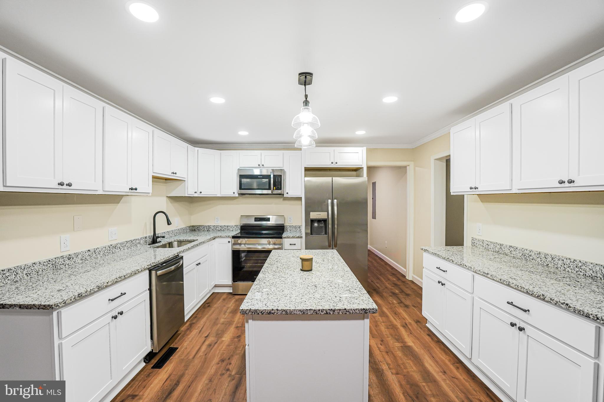 767 Loving Road Zion Crossroads, VA 22942 - Photo 10 of 33 a large kitchen with stainless steel appliances granite countertop a lot of counter space and wooden cabinets