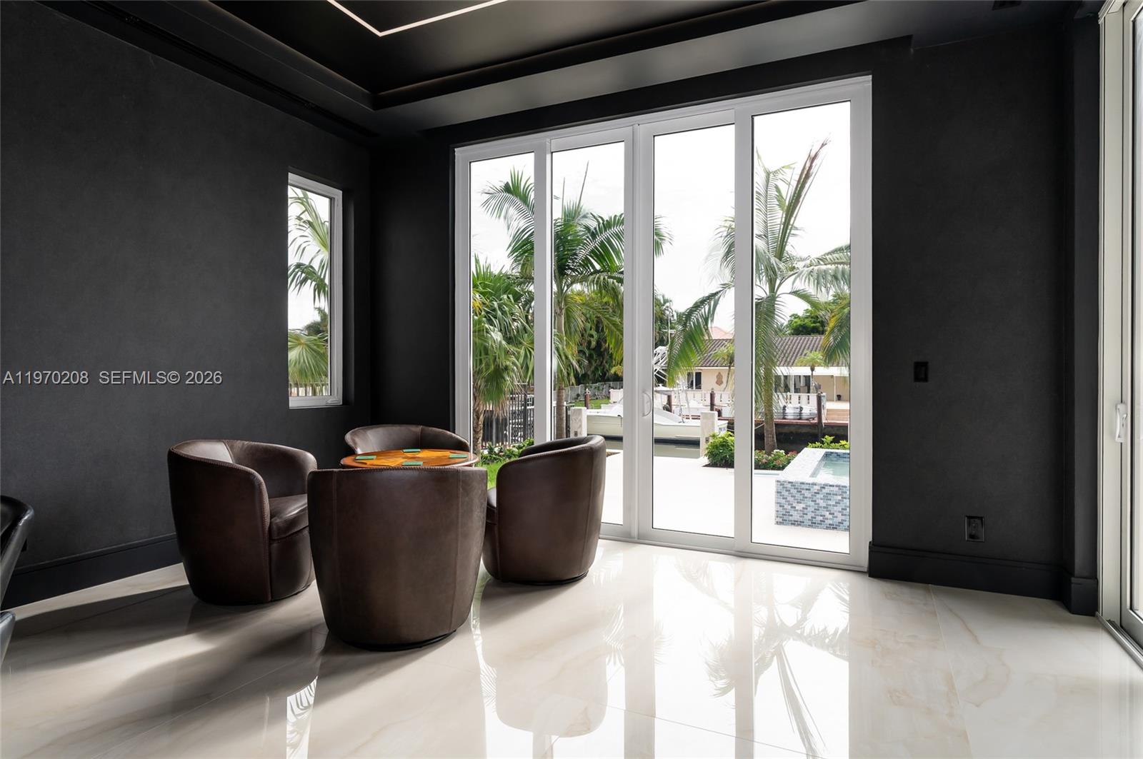 3740 Northeast 29th Avenue Lighthouse Point, FL 33064 - Photo 16 of 50 a living room with furniture and large windows