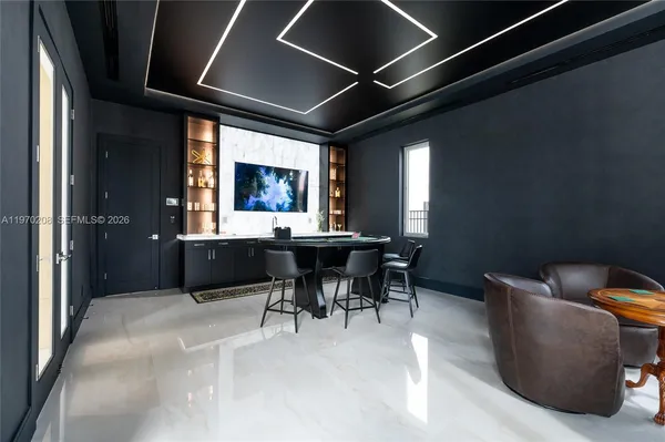 a bathroom with a granite countertop toilet sink and mirror
