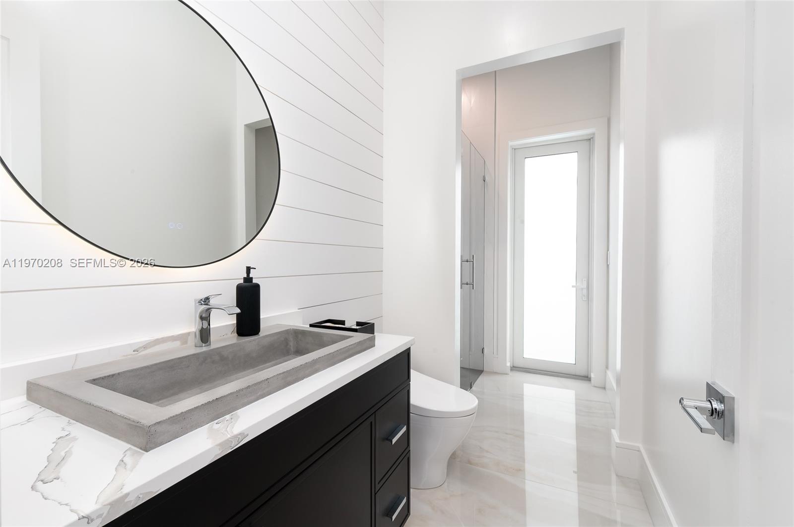 3740 Northeast 29th Avenue Lighthouse Point, FL 33064 - Photo 18 of 50 a bathroom with a sink vanity and a mirror