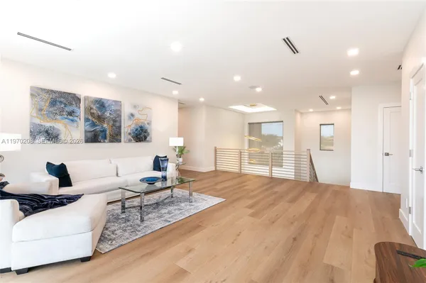 a living room with furniture and large windows