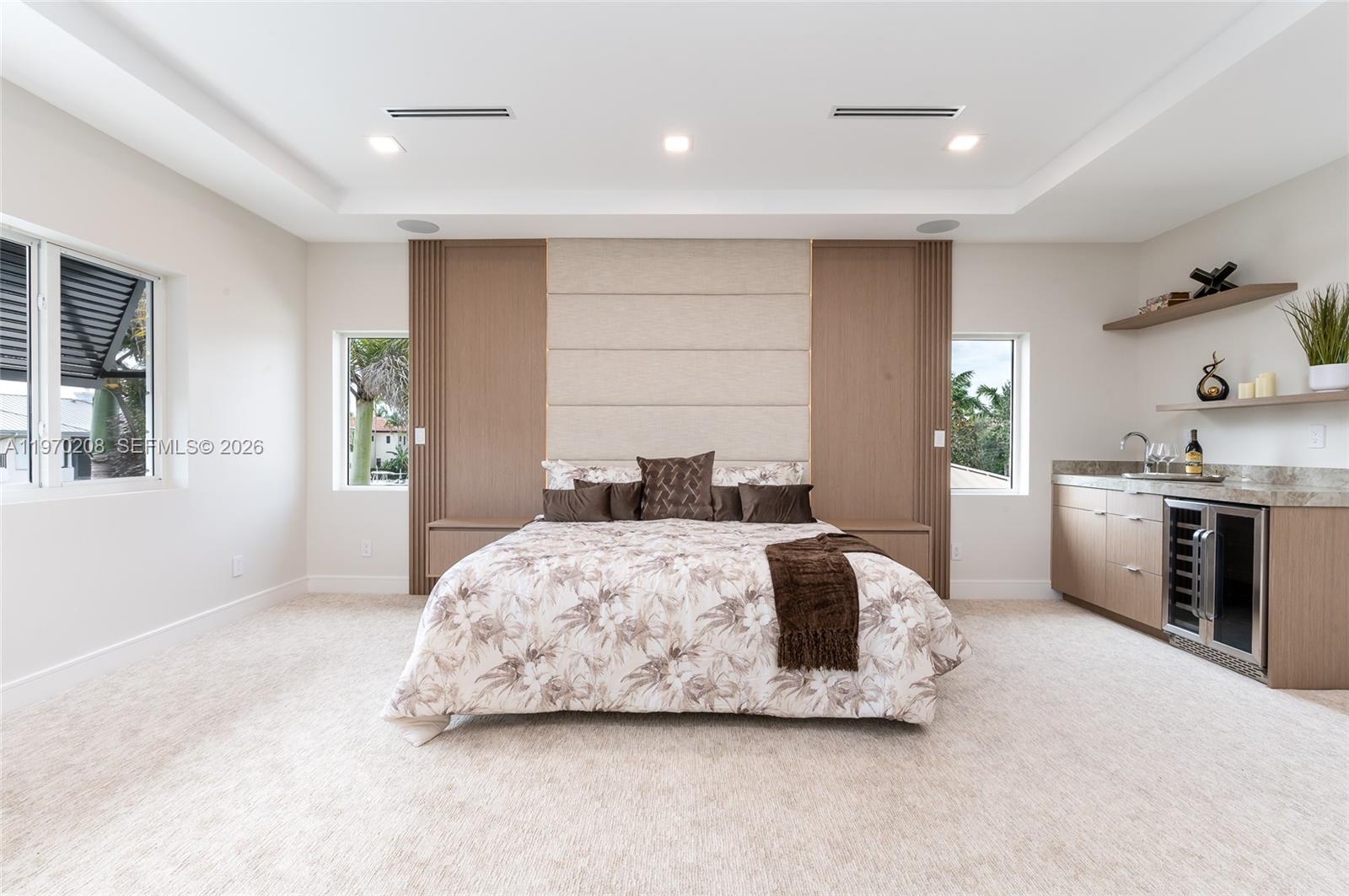 3740 Northeast 29th Avenue Lighthouse Point, FL 33064 - Photo 26 of 50 a spacious bedroom with a bed and a cabinets