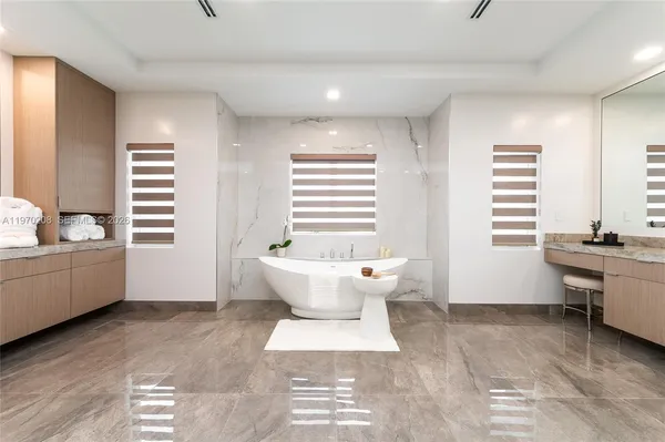 a bathroom with a double vanity sink mirror and shower