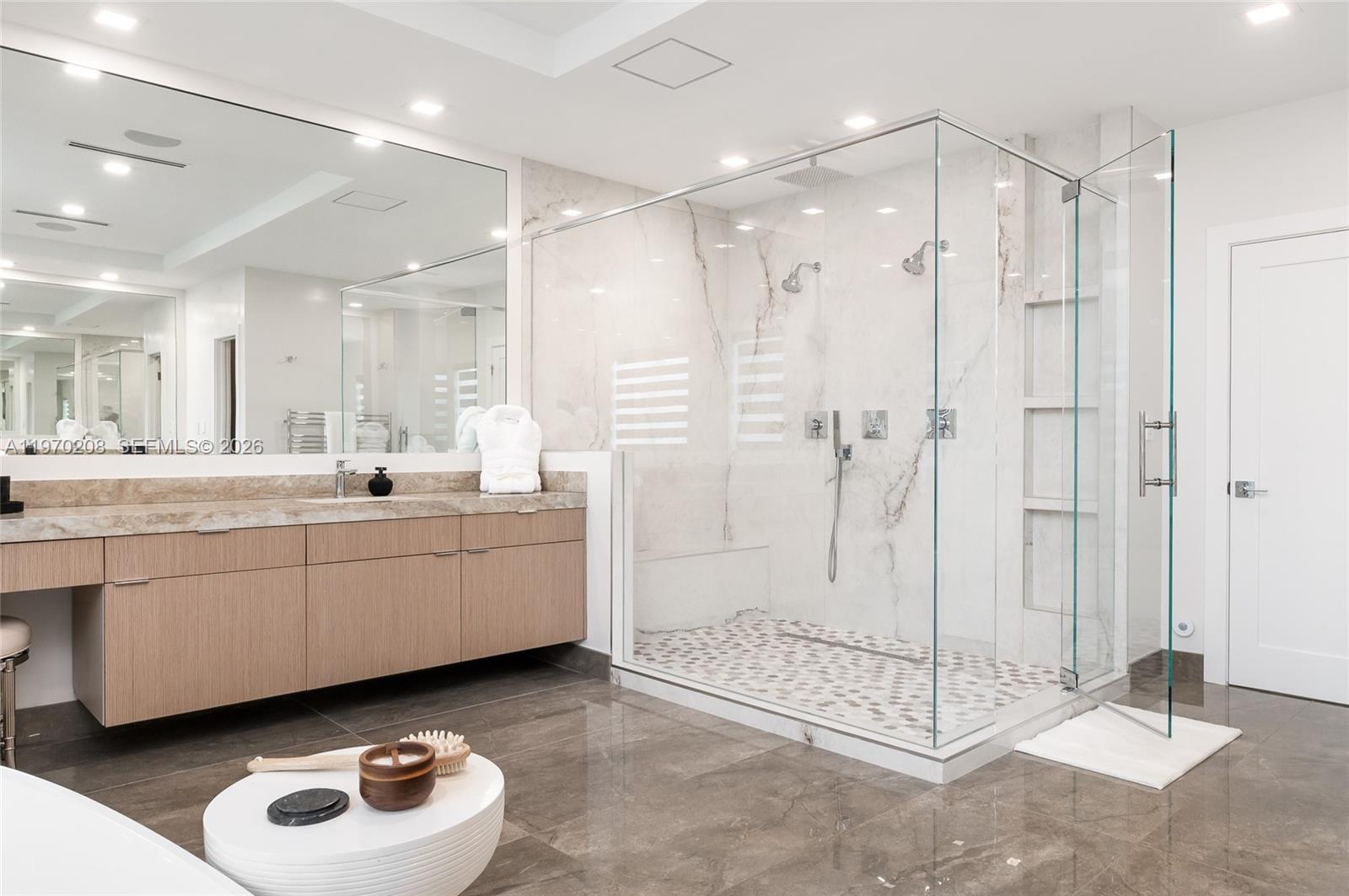 3740 Northeast 29th Avenue Lighthouse Point, FL 33064 - Photo 33 of 50 a bathroom with a double vanity sink mirror and shower
