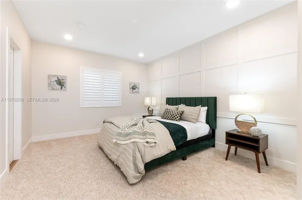 a bedroom with a large bed and a window