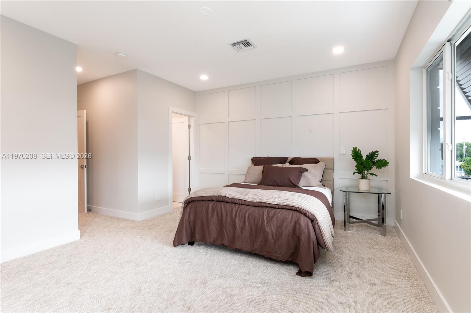 3740 Northeast 29th Avenue Lighthouse Point, FL 33064 - Photo 36 of 50 a bedroom with a bed and a window