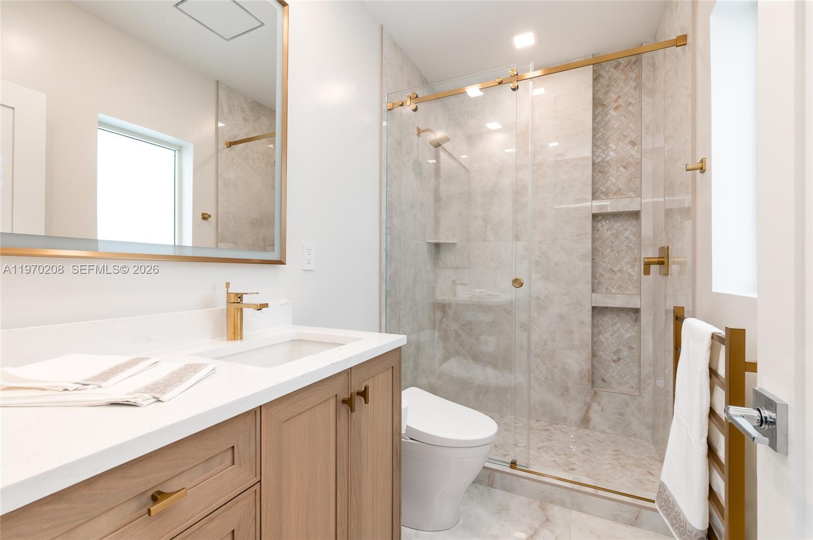 3740 Northeast 29th Avenue Lighthouse Point, FL 33064 - Photo 37 of 50 a bathroom with a sink a toilet and shower