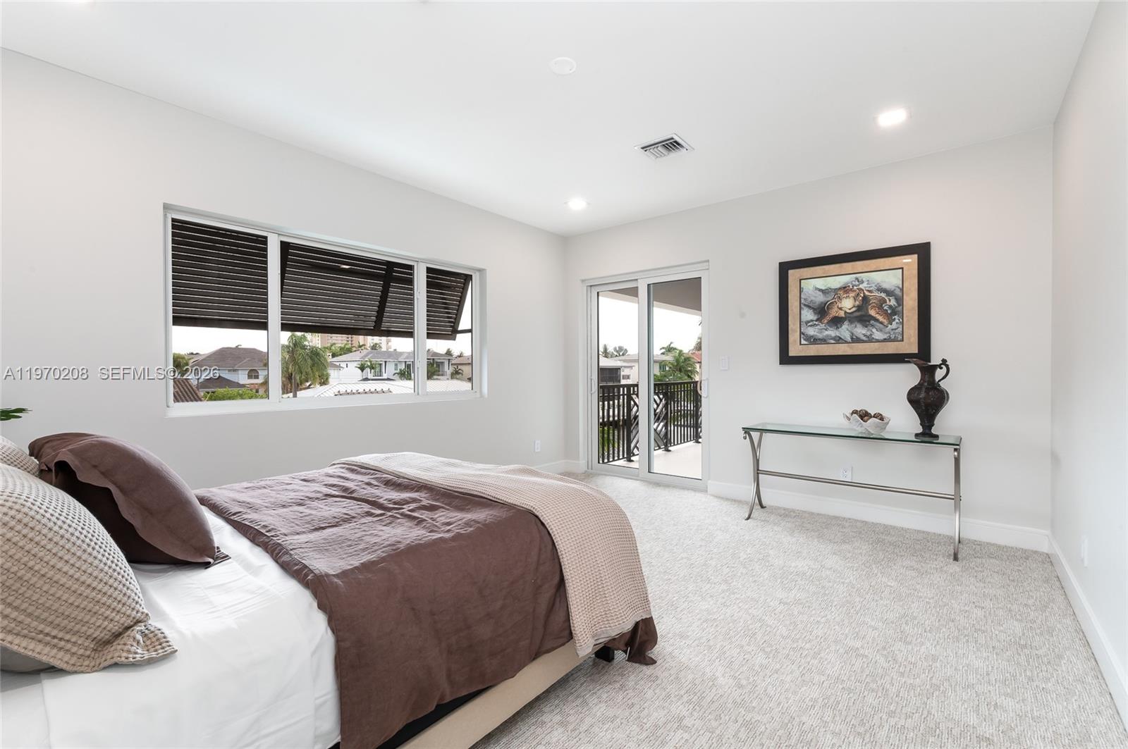 3740 Northeast 29th Avenue Lighthouse Point, FL 33064 - Photo 38 of 50 a bedroom with a large bed and a window