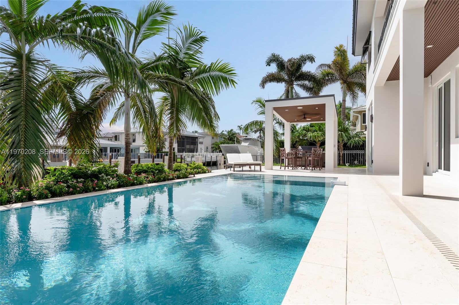 3740 Northeast 29th Avenue Lighthouse Point, FL 33064 - Photo 44 of 50 a view of swimming pool with palm trees