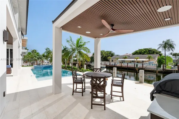 a view of a patio with table and chairs and potted plants