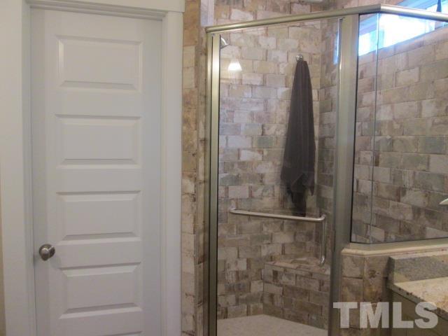 633 Georgetown Road Raleigh, NC 27608 - Photo 54 of 99 a bathroom with a glass shower door