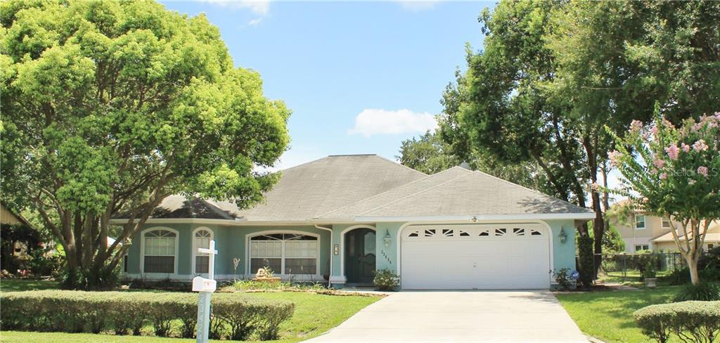 23424 Sierra Road Land O' Lakes, FL 34639 - Photo 1 of 1 Facade of 23424 Sierra Road adorns decorative coach lighting, natural landscape, and mountain rock landscape border. Bright open windows let plenty of natural lighting flow through!
