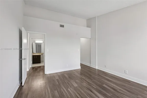 a view of a room with wooden floor