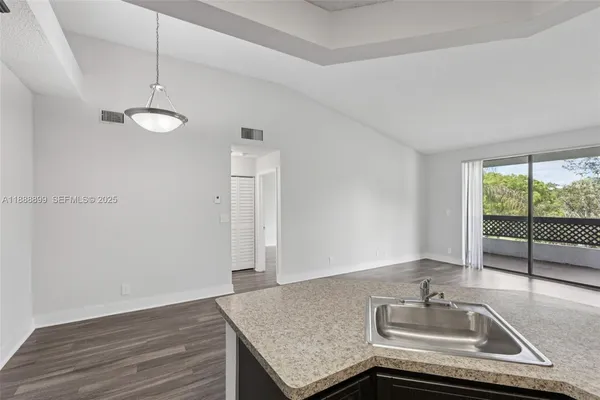 a kitchen with a sink refrigerator and microwave