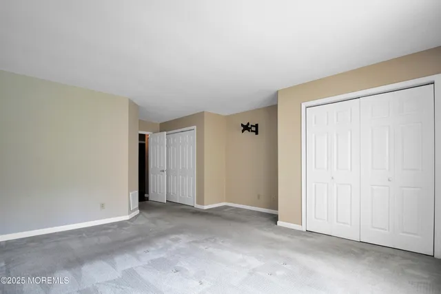 a spacious bathroom with a granite countertop sink and a mirror