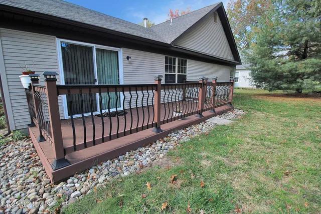 a backyard of a house with table and chairs
