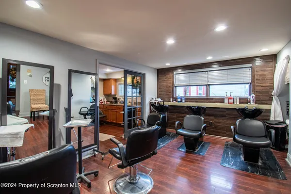 a living room with furniture a rug and kitchen view