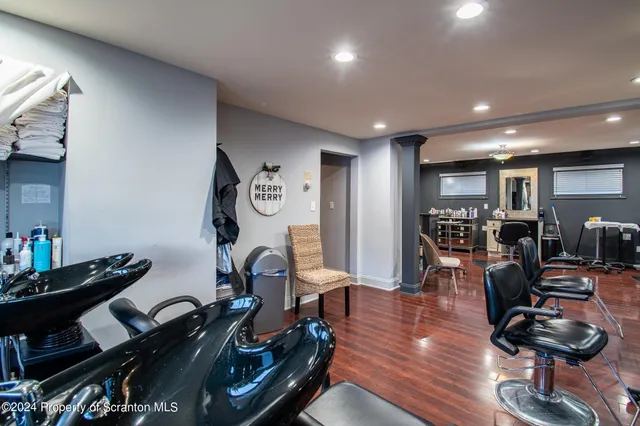 a room with lots of chairs and wooden floor